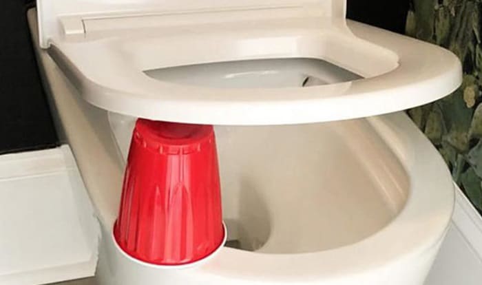 Why Put a Red Cup Under The Toilet Seat?